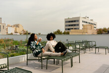 Women Relaxing At Office Building Rooftop