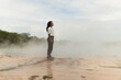 © Kike Arnaiz/Stocksy - Arab woman near steaming geothermal spring