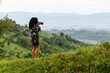 © Kike Arnaiz/Stocksy - Female photographer taking photo of scenery