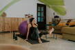 © Eloisa Ramos/Stocksy - Middle age woman using fitball at home