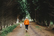© Daniel Gonzalez/Stocksy - Woman walking with dog in woods