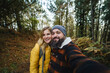 © Daniel Gonzalez/Stocksy - Happy traveling couple taking selfie