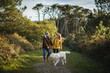 © Daniel Gonzalez/Stocksy - Happy couple with dog in park