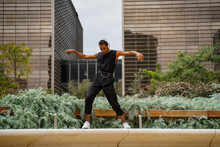 Stylish Man Dancing In Front Of Office Building