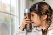 © Lauren Lee/Stocksy - Child looking closely at calm down jar