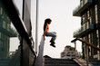 © Mauro Grigollo/Stocksy - A woman jumping from a handrail