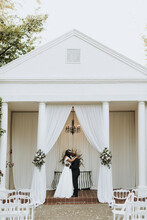 Bride And Groom Kissing At Wedding Venue