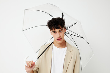 handsome guy transparent umbrella a man in a light jacket isolated background unaltered