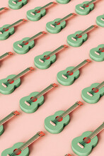Pattern Of Green Cartoon Guitars On Pink. 3d Render