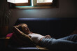 © Michela Ravasio/Stocksy - Young woman resting on the couch
