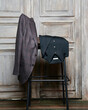 © Elena Kharichkina/Stocksy - Elegant apparels on chair near door