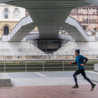 © Hakan & Sophie/Stocksy - running in urban landscape