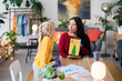 © Studio Marmellata/Stocksy - Cheerful woman and girl studying together