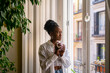 © Luis Velasco/Stocksy - Cute Black Girl Warming Up Having A Hot Drink At Home