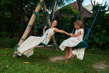 Mother With Daughter On The Swing