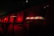 © Yakov Knyazev/Stocksy - red velvet chairs in the theater crossed with tape