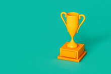 Yellow Trophy On Green Background With Copy Space