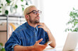 © Studio Marmellata/Stocksy - Thoughtful man with laptop in office