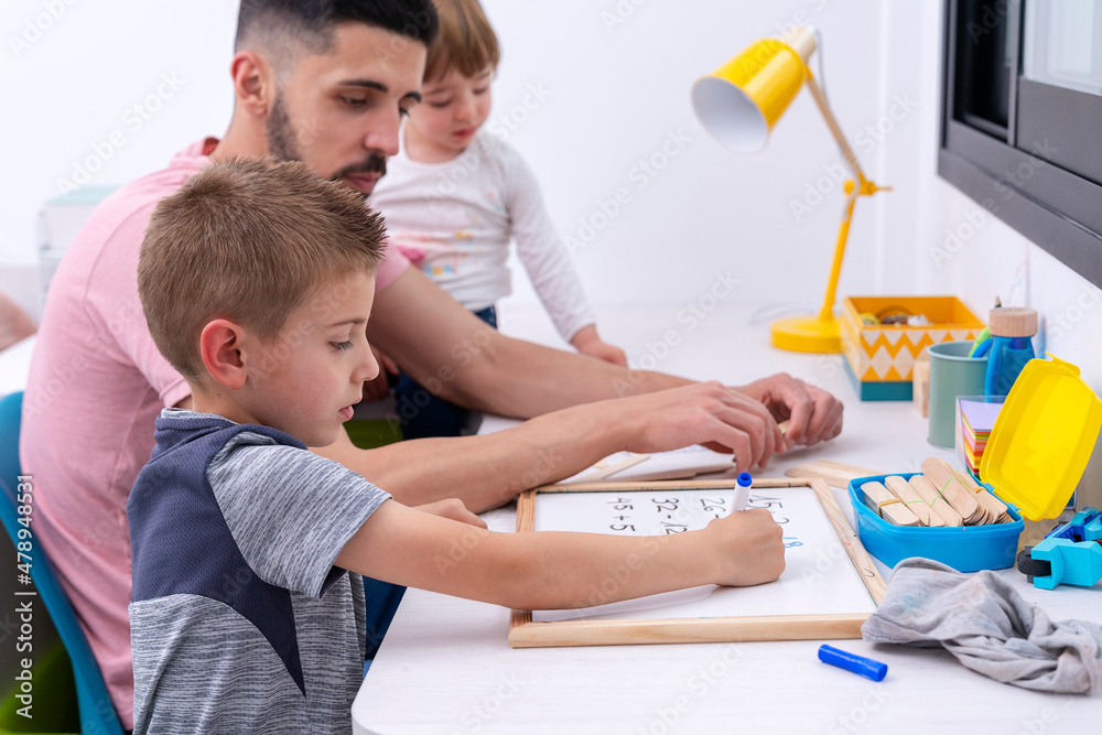 Father helping his son with homework Stock Photo | Adobe Stock