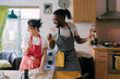 © Mattia/Stocksy - Young couple Singing while cooking