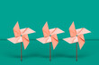 © Giada Canu/Stocksy - frontal view of pink Pinwheels. wind energy concept.