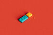 © Giada Canu/Stocksy - Colorful building blocks isolated on a red background