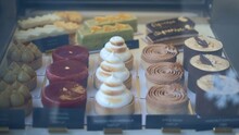 Range Of Beautiful Delicious Confectionery, Cheesecakes, Cake Slices, Tarts, Creamy And Crunchy Desserts On The Display Case