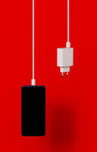 Modern Smartphone And Charger On Red Background
