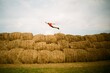 © Alina Hvostikova/Stocksy - Man flying like superhero above haystacks