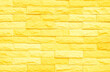 © siripak - Brick wall painted with yellow paint pastel bright tone texture background design backdrop.
