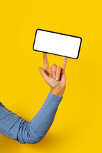 Anonymous Person Balancing A Mobile Phone With Fingers

