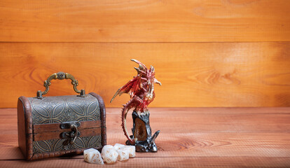 Wall Mural - Ivanovo, Russia - 02.11.2021: D20 and set of role playing white dices, toy miniature of dragon and storage box for playing Dungeons and Dragons role-playing game on wooden background