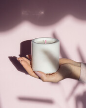 White Scented Candle And Female Hand