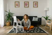 Woman Browsing Online Yoga Classes At Home