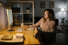 Woman Using Desktop Computer At Night