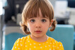 © Albert Martinez/Stocksy - little girl looking shyly and curiously at the camera