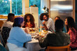 © BONNINSTUDIO/Stocksy - Multiracial friends gathering around table