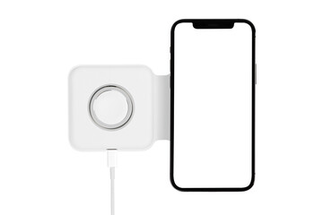 Smartphone on wireless charging on a white background. Smartphone is being charged on wireless charging close-up.