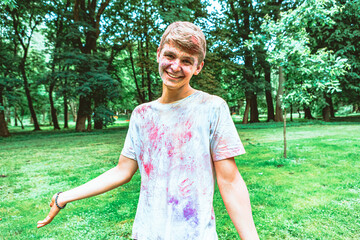 Canvas Print - portrait of young happy man dirt in holi paints