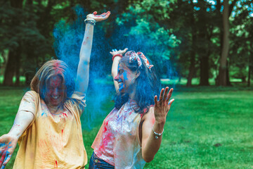 Wall Mural - two women girlfriends having fun at holi fest