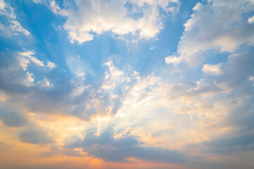 Wall Mural - sunset / sun rise sky with rays of  light shining clouds and sky background and texture