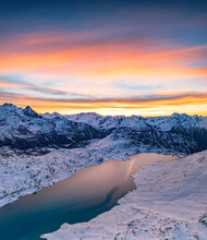 Aerial View Of Frozen Lake Lago Bianco At Bernina Mountain Pass Covered With Snow At Sunrise, Engadine, Graubunden, Switzerland