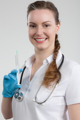 Wall Mural - female doctor or nurse with syringe pulled up with a vaccination serum