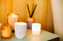 Many Burning Lighting Scented Candles And Aromatic Incense Sticks On Table, Meditation Place At Home
