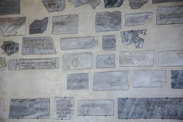 Wall Mural - Pagan and early Christian Latin inscriptions in the portico of the Basilica of Santa Maria in Trastevere in Rome