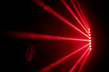 Bright Red Neon Laser Lights Illuminate The Darkness Creating Lines And Triangle Shapes In Sci-fi Effect.
