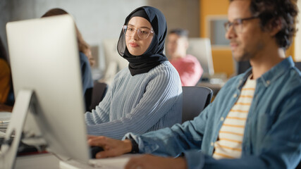 Sticker - Curious Female Muslim Student Wearing a Hijab, Studying in Modern University with Diverse Multiethnic Classmates. College Scholars Work in College Room, Learning IT, Programming or Computer Science.