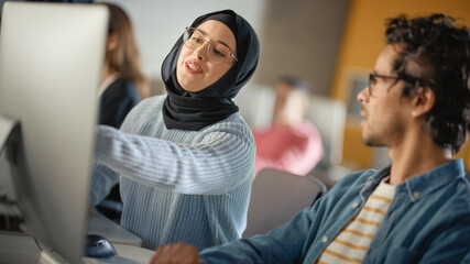 Fototapete - Female Muslim Student Wearing Hijab, Studying in Modern University with Diverse Multiethnic Classmates. She Asks Scholar a Question in College Room. Learning Software Engineering or Computer Science.