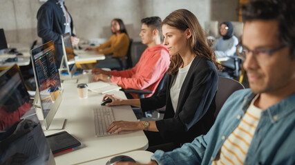 Fototapete - Diverse Multiethnic Group of Female and Male Students Sitting in College Room, Learning Computer Science. Young Scholars Study Information Technology on Computers in University, Getting Knowledgeable.