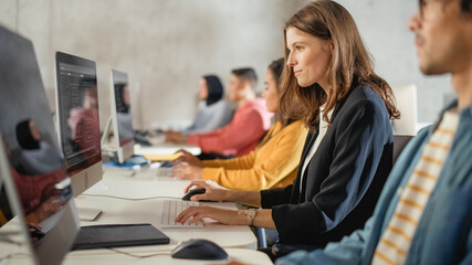 Fototapete - Diverse Multiethnic Group of Female and Male Students Sitting in College Room, Learning Computer Science. Young Scholars Study Information Technology on Computers in University, Writing Code in Class.